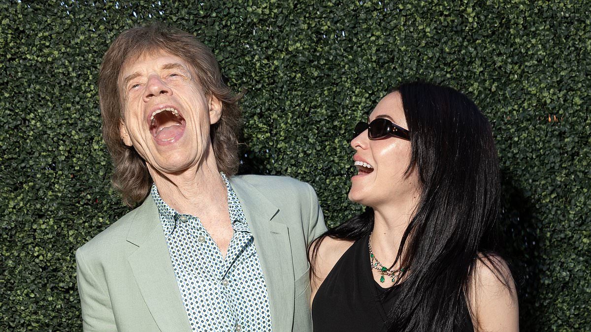 Mick Jagger, 82, can't contain his laughter as he poses with fiancée Melanie Hamrick, 38, at event in California after he was left devastated after England's World Cup defeat