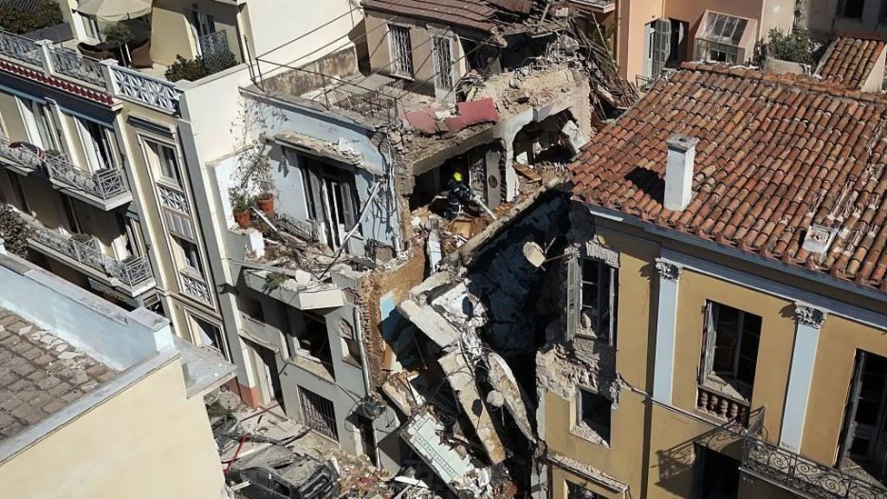 One dead and five missing after explosion destroys building close to Acropolis in Athens