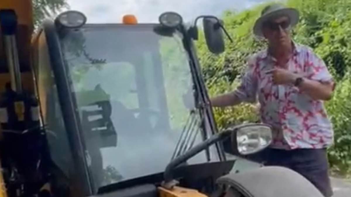 Moment wealthy businessman drives his JCB toward Olympic champion who was protesting against new waste incinerator