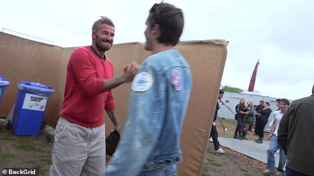 Proud parents David and Victoria Beckham wrap their arms around son Cruz after his 'amazing' Reading gig as his fashion designer mum praises his edgy look in backstage clip